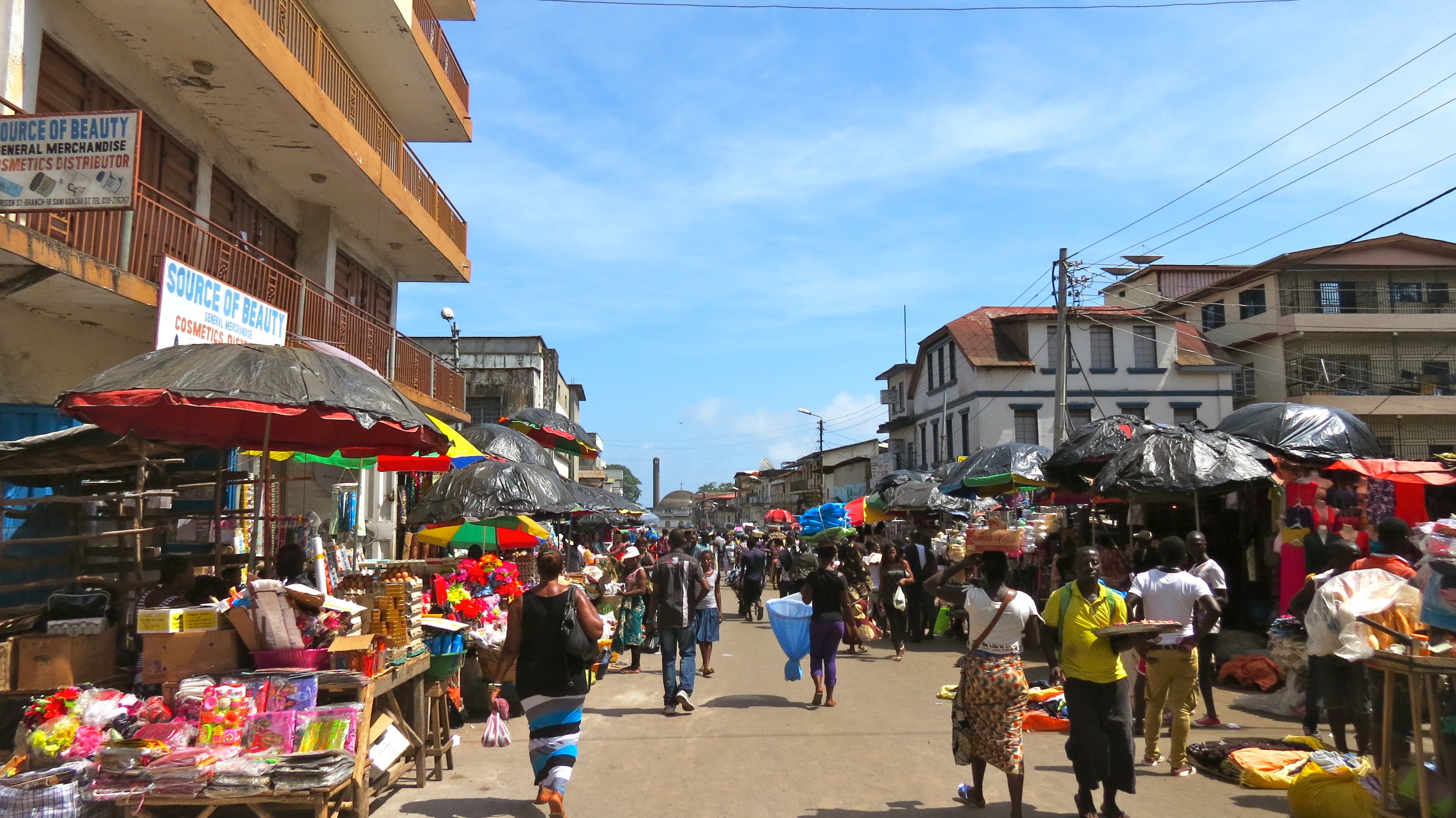 People walking down a busy street in Kampala, Uganda.
